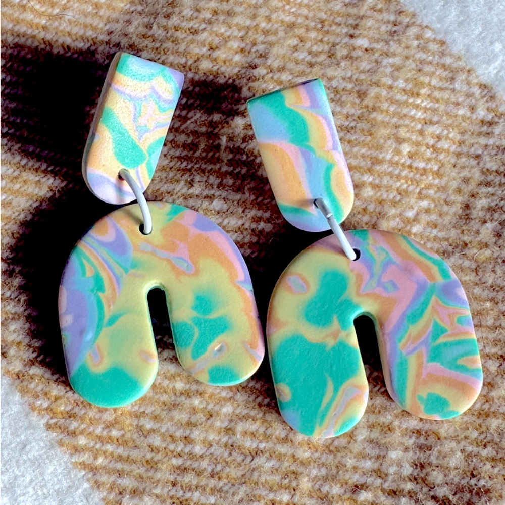 Pastel modern handmade clay abstract swirl pattern earrings.